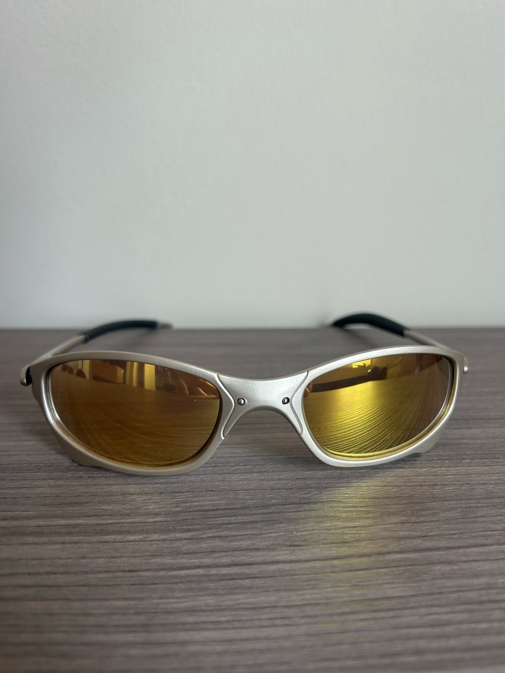 Oakley Silver Frame Sunglasses with Gold Mirrored Lenses